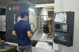 Operator working at a CNC machining center on the shop floor