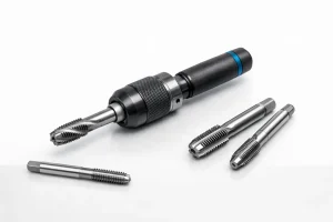 Thread tapping tool holder with three machine taps on a white background