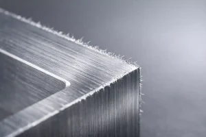 Close-up of burrs on the edge of a freshly machined metal part