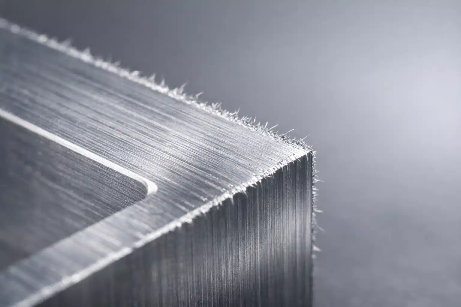 Close-up of burrs on the edge of a freshly machined metal part