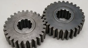 Two machined steel gears with internal spline bores